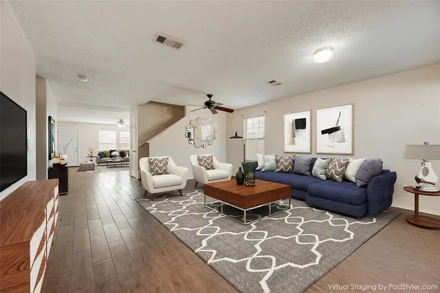 a living room with furniture and wooden floor