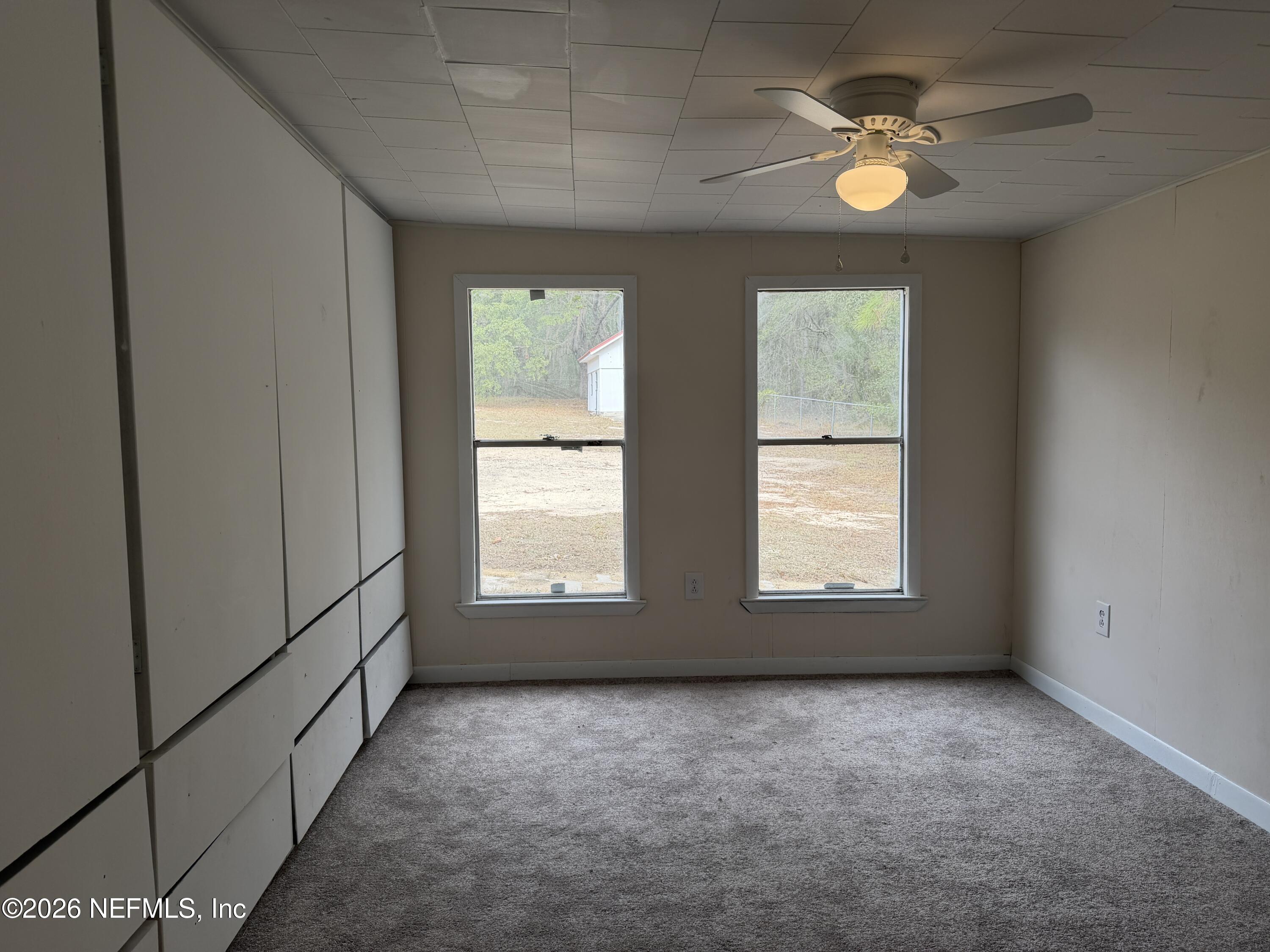 110 Kitty Lane Interlachen, FL 32148 - Photo 13 of 14 an empty room with window ceiling fan