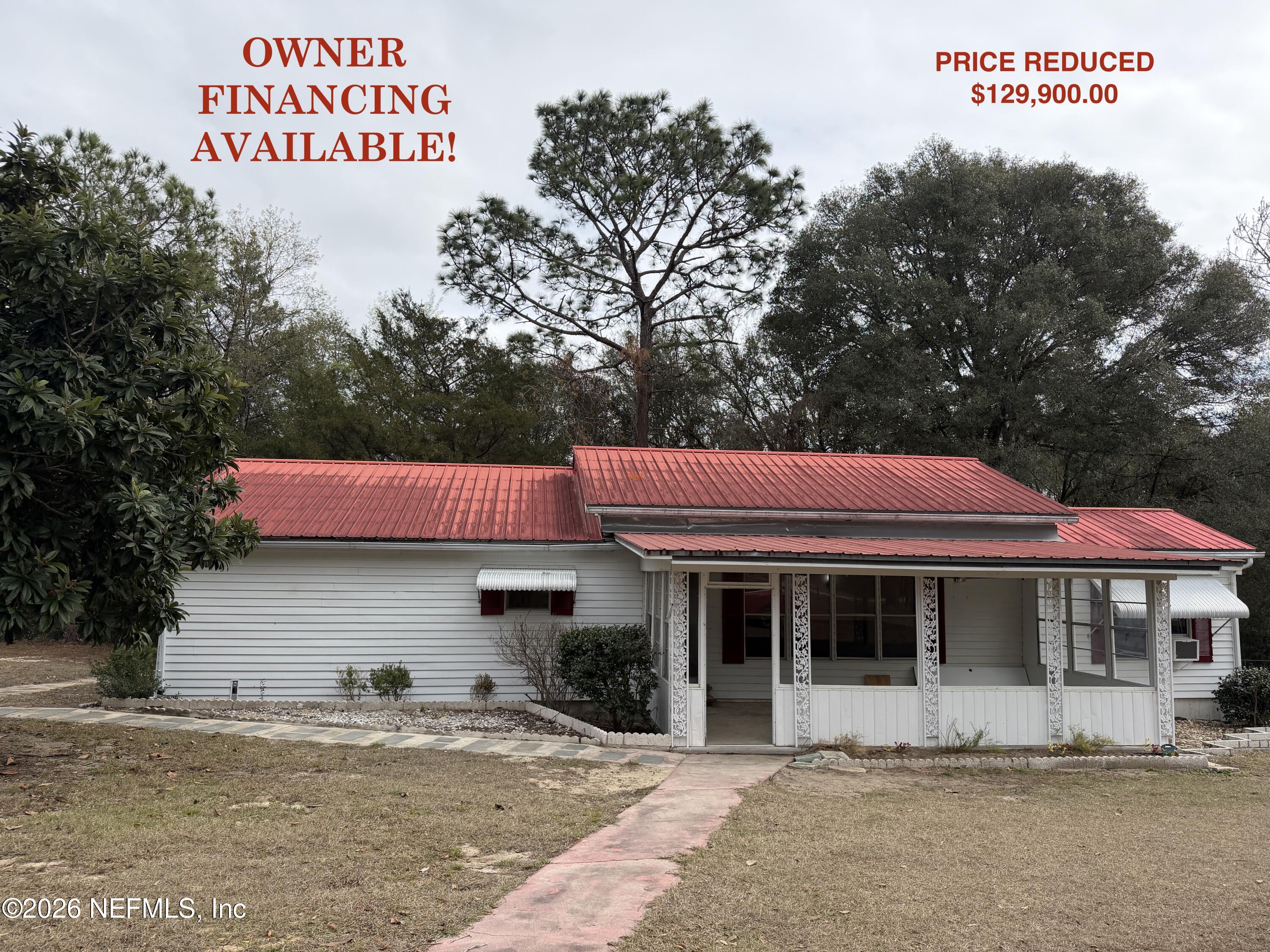 110 Kitty Lane Interlachen, FL 32148 - Photo 2 of 14 a view of a cafe with a table and chairs under an umbrella