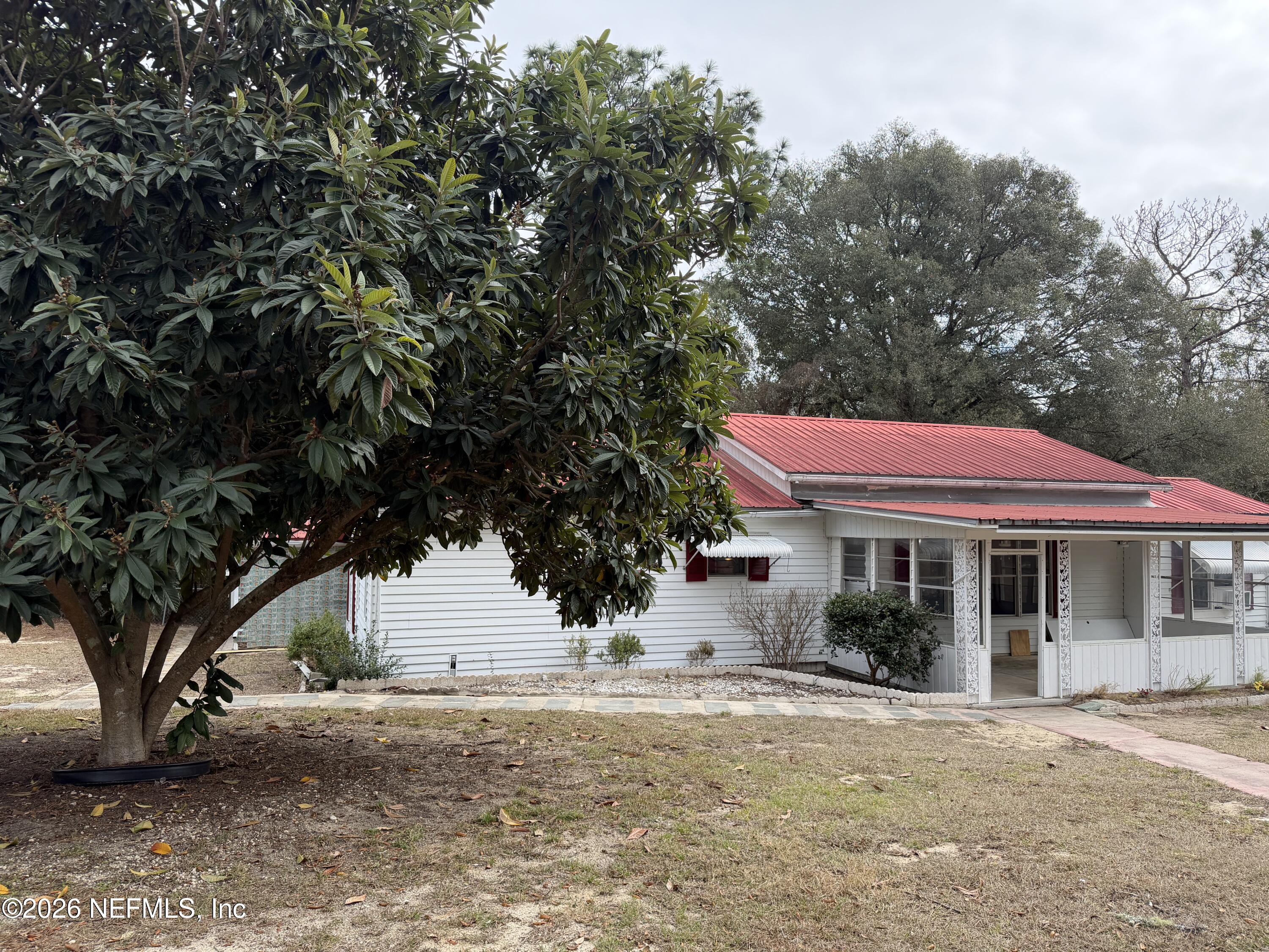 110 Kitty Lane Interlachen, FL 32148 - Photo 4 of 14 a front view of a house with a yard and garage