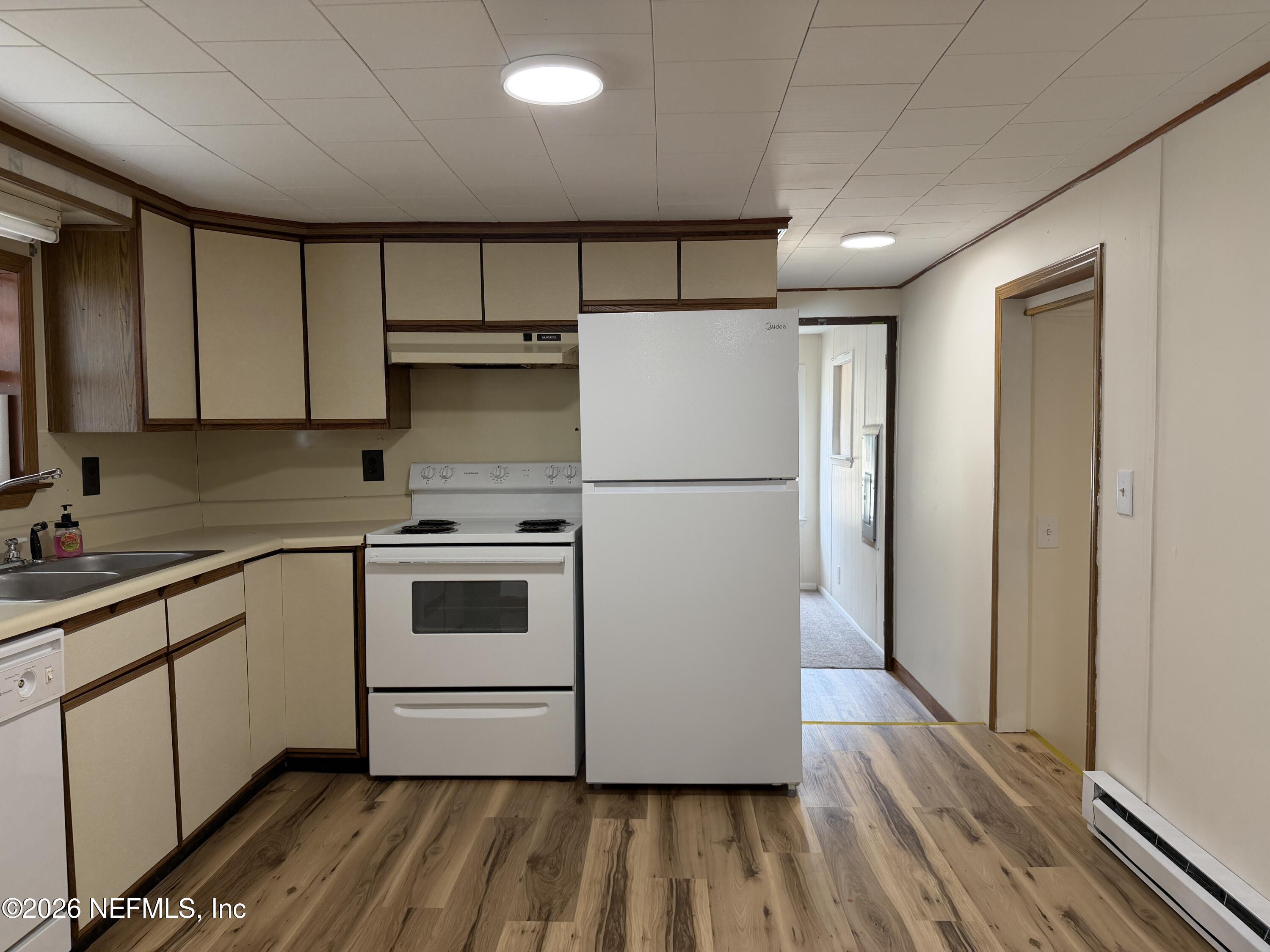110 Kitty Lane Interlachen, FL 32148 - Photo 7 of 14 a white refrigerator freezer sitting inside of a kitchen