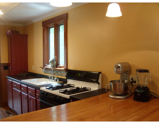 2753 South Athol Road Athol, MA 01331 - Photo 8 of 14 a kitchen with a stove and a dining table