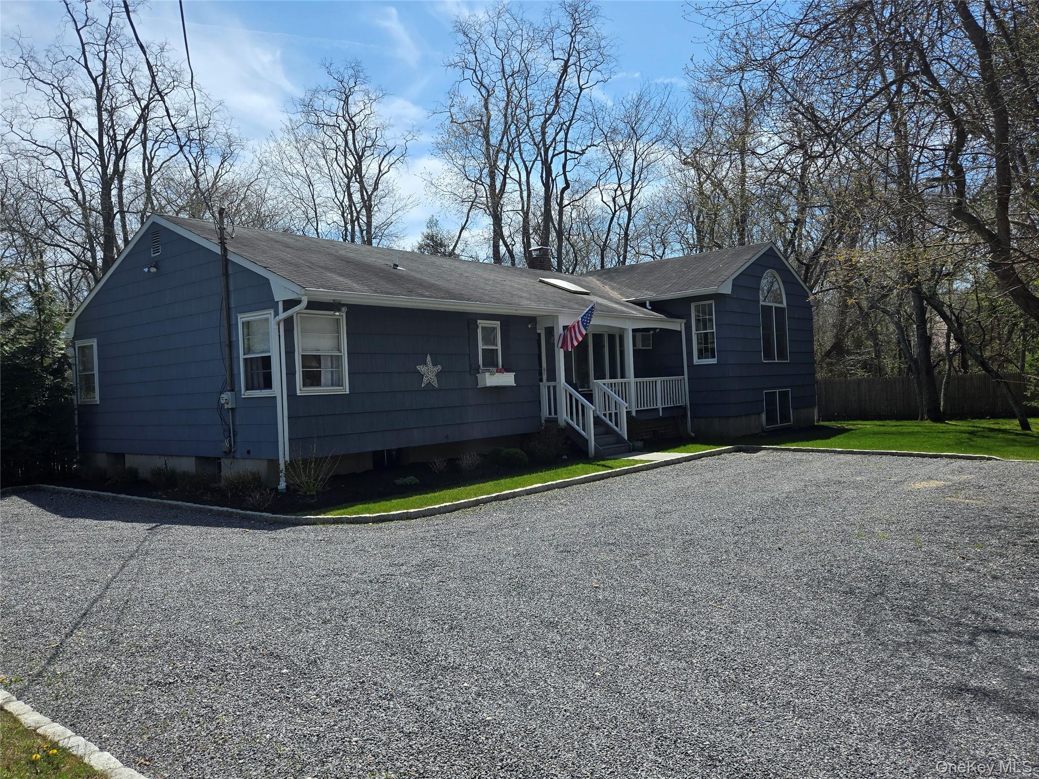 870 Noyack Road Southampton, NY 11968 - Photo 1 of 19 a front view of a house with a yard and garage