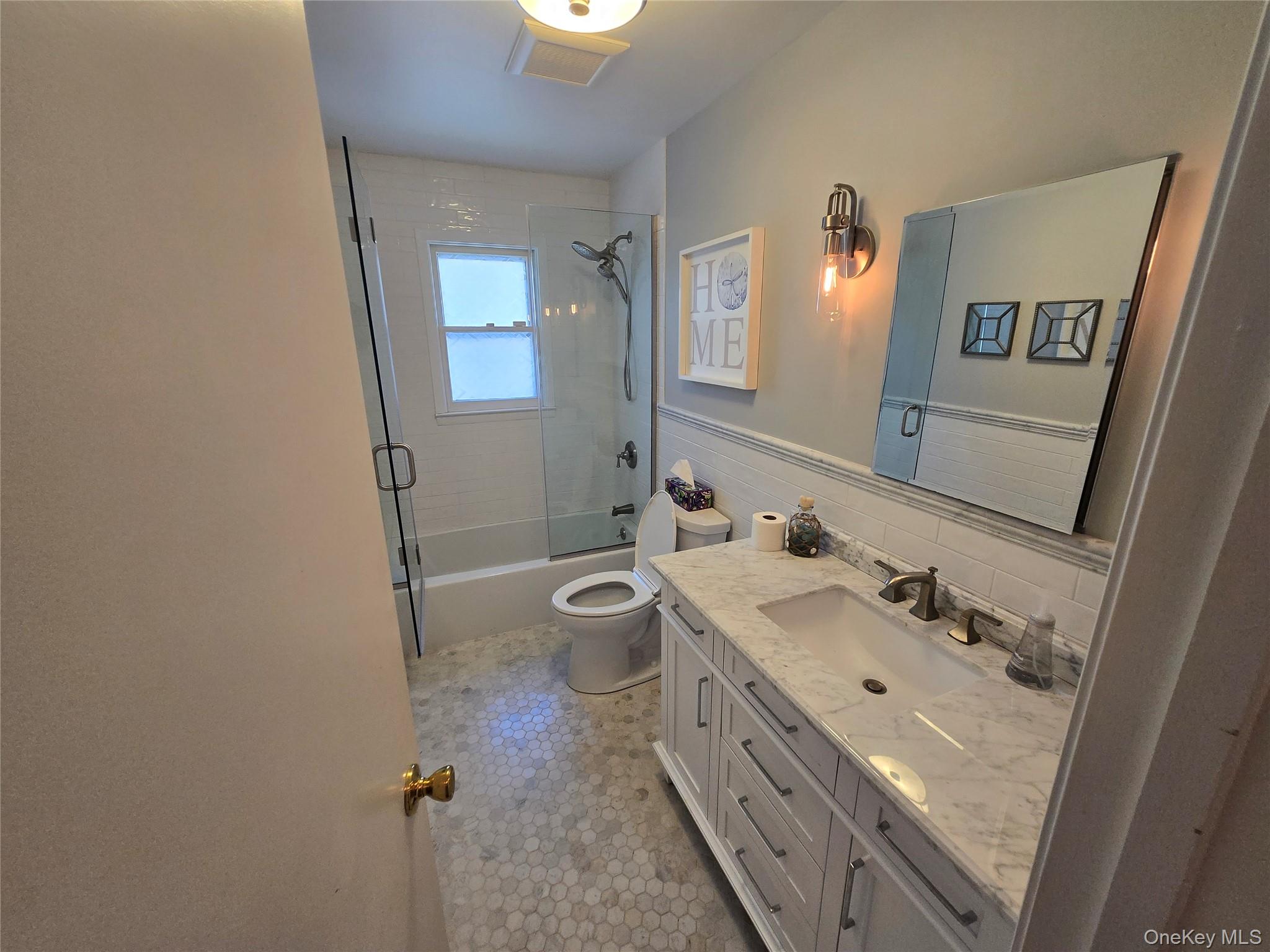 870 Noyack Road Southampton, NY 11968 - Photo 11 of 19 a bathroom with a double vanity sink and mirror