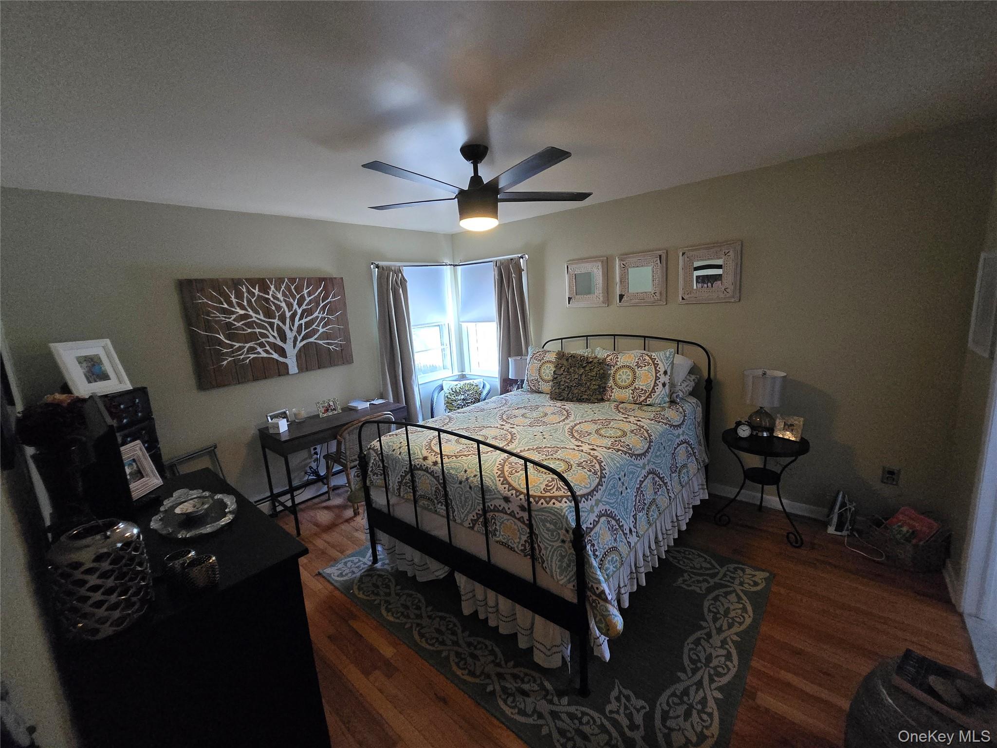870 Noyack Road Southampton, NY 11968 - Photo 12 of 19 a bedroom with a bed and a chandelier