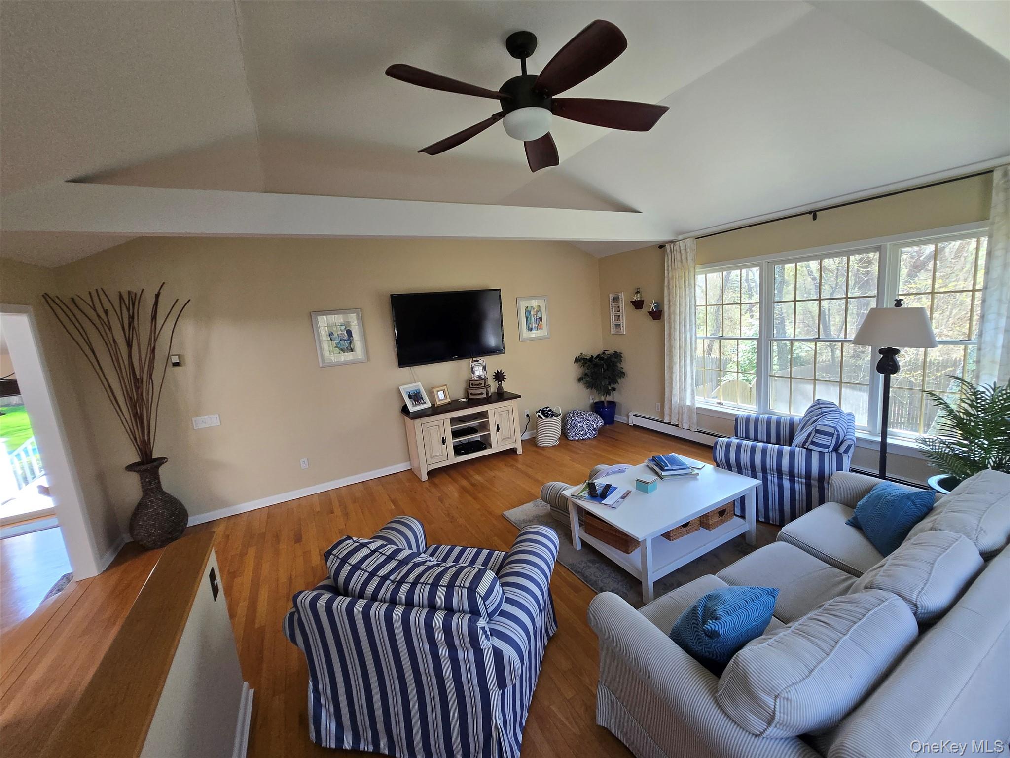 870 Noyack Road Southampton, NY 11968 - Photo 4 of 19 a living room with furniture a flat screen tv and a large window