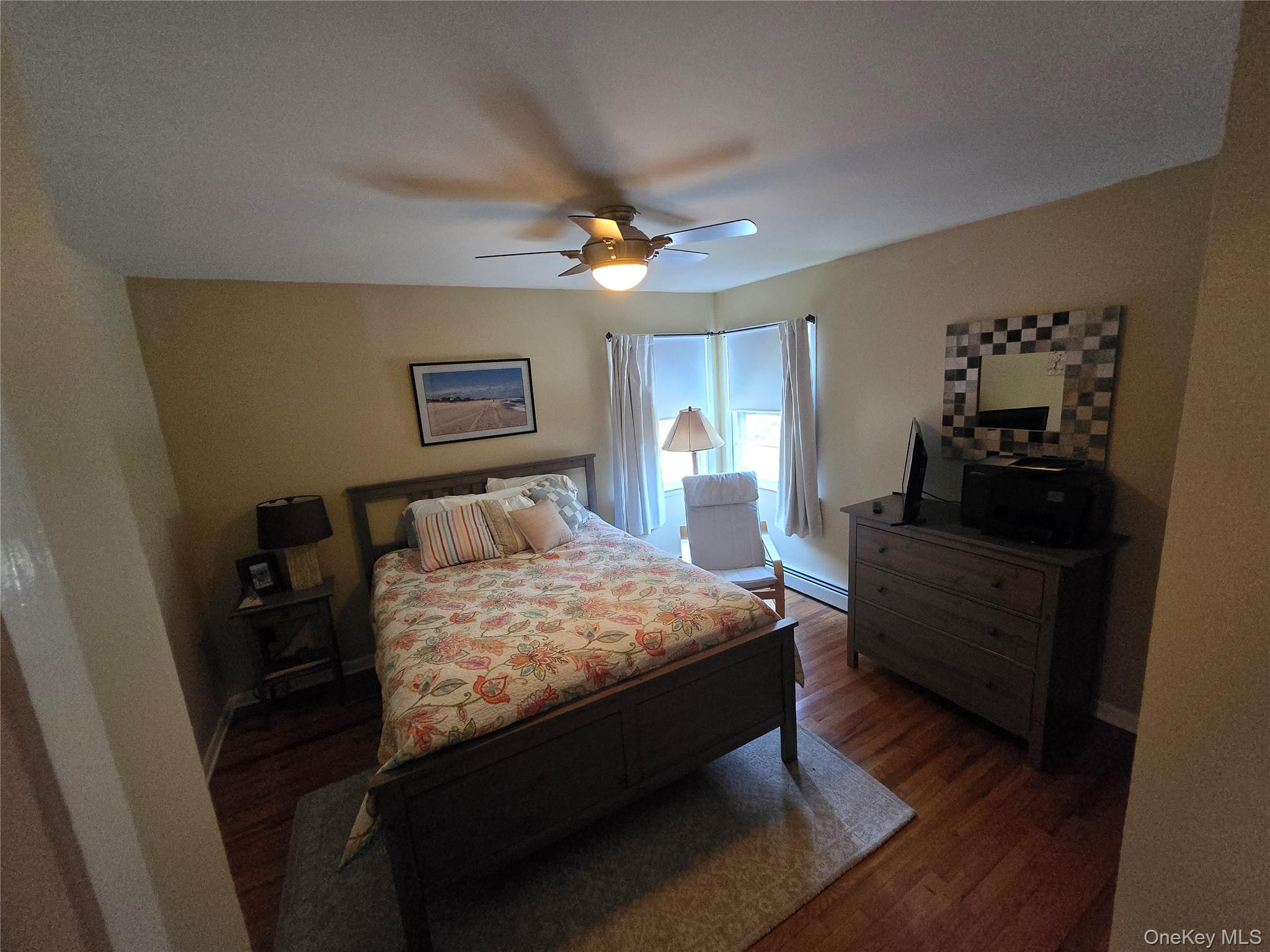 870 Noyack Road Southampton, NY 11968 - Photo 10 of 19 a spacious bedroom with a bed and cabinet