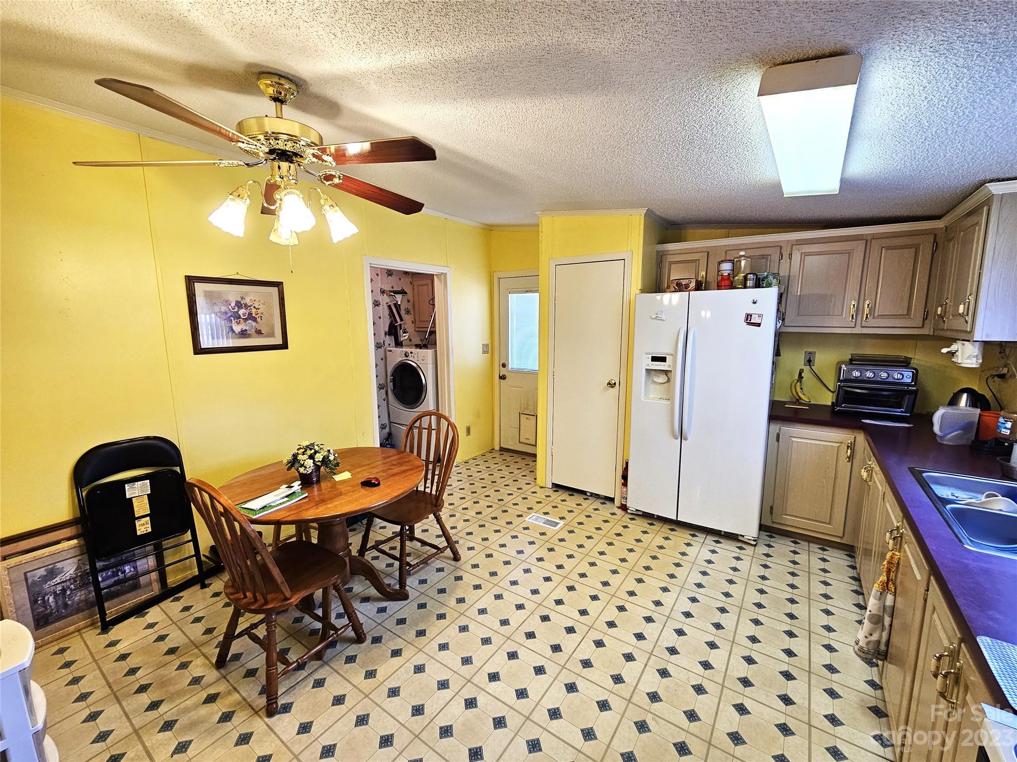 2955 Piney Road Morganton, NC 28655 - Photo 15 of 43 a living room with furniture a flat screen tv and a refrigerator