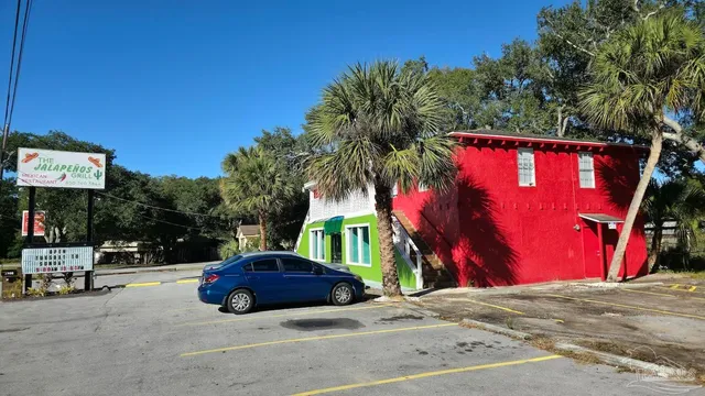 a view of a house with a yard and stairs