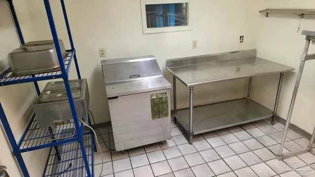 a kitchen with a refrigerator and cabinets