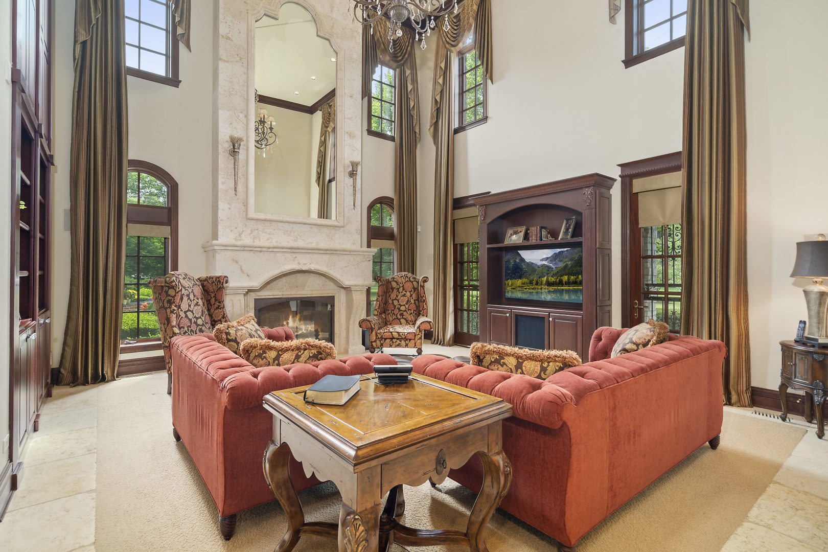 33W571 White Thorne Road St. Charles, IL 60174 - Photo 16 of 46 a living room with furniture a fireplace and floor to ceiling windows
