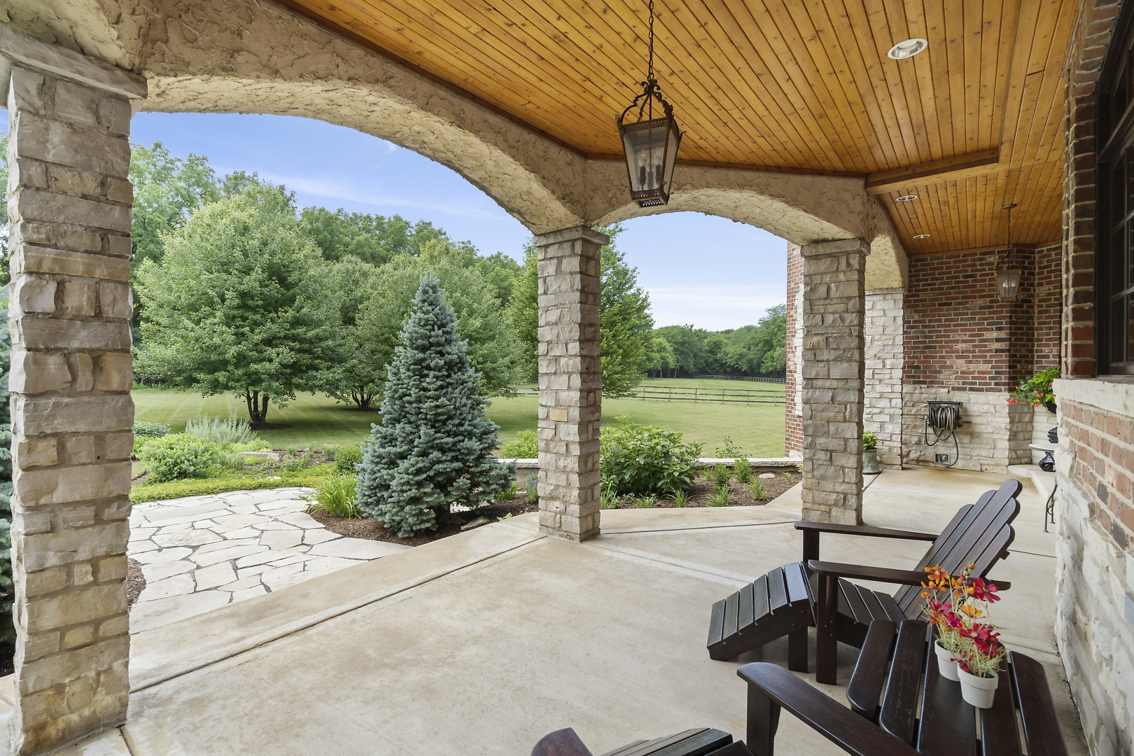 33W571 White Thorne Road St. Charles, IL 60174 - Photo 45 of 46 a view of a patio with table and chairs potted plants with wooden floor and fence