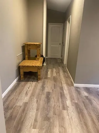 a view of a bedroom with wooden floor and bedroom