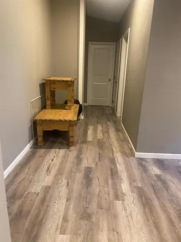 a view of a bedroom with wooden floor and bedroom