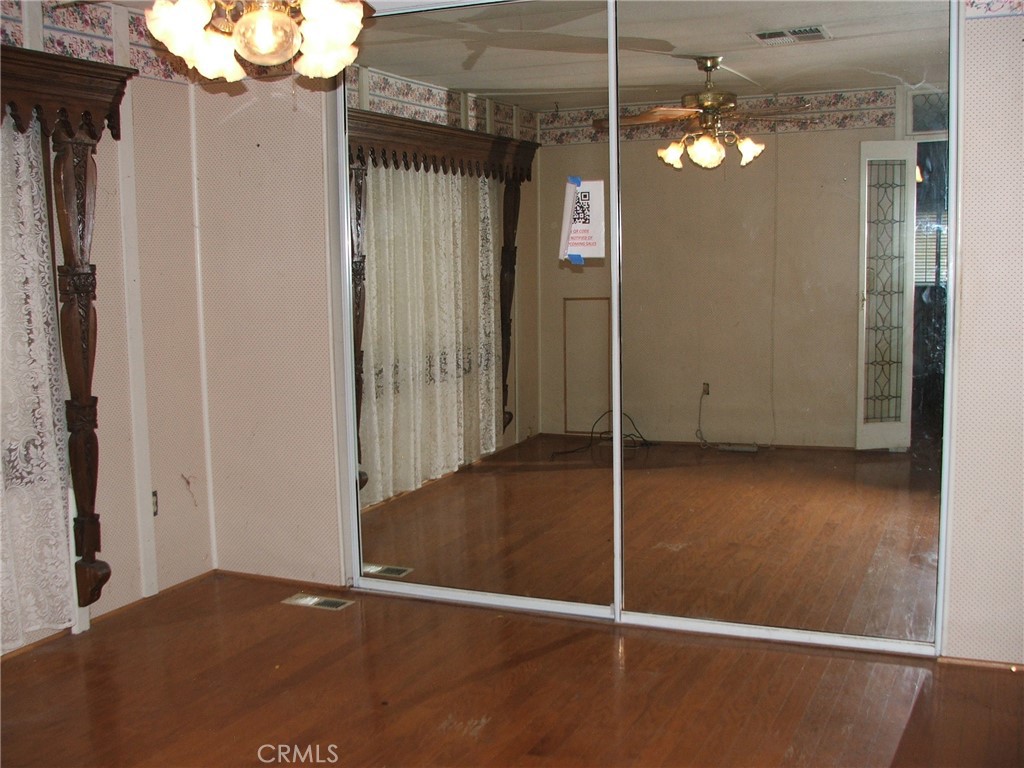 9800 Base Line Road, Unit 68 Rancho Cucamonga, CA 91701 - Photo 4 of 22 an empty room with wooden floor mirror and windows