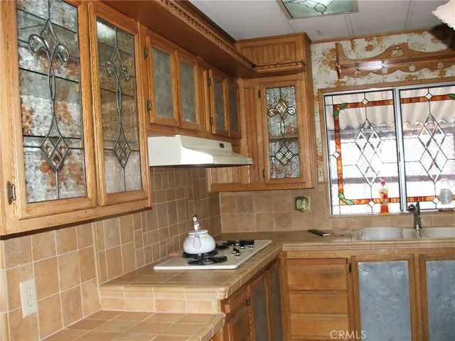 a kitchen with granite countertop a sink and a window
