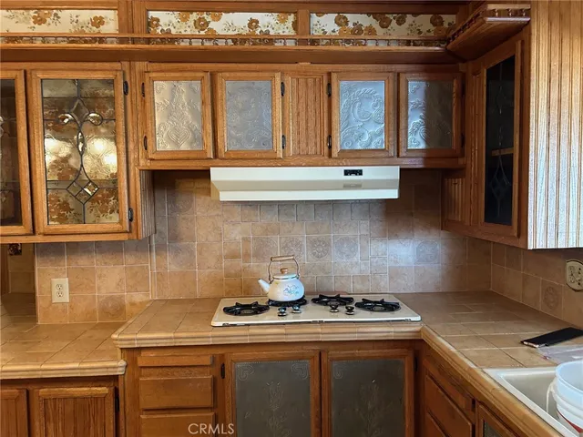 a kitchen with stainless steel appliances granite countertop a stove and a microwave