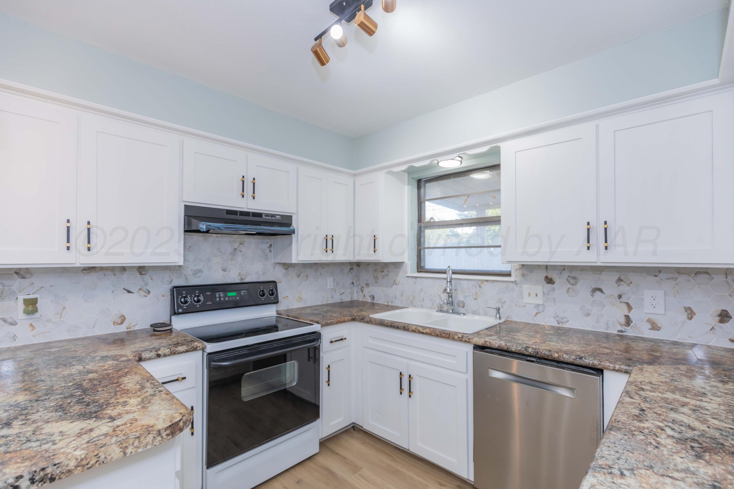 7912 Gerald Drive Amarillo, TX 79121 - Photo 13 of 45 a kitchen with stainless steel appliances granite countertop a sink stove and cabinets