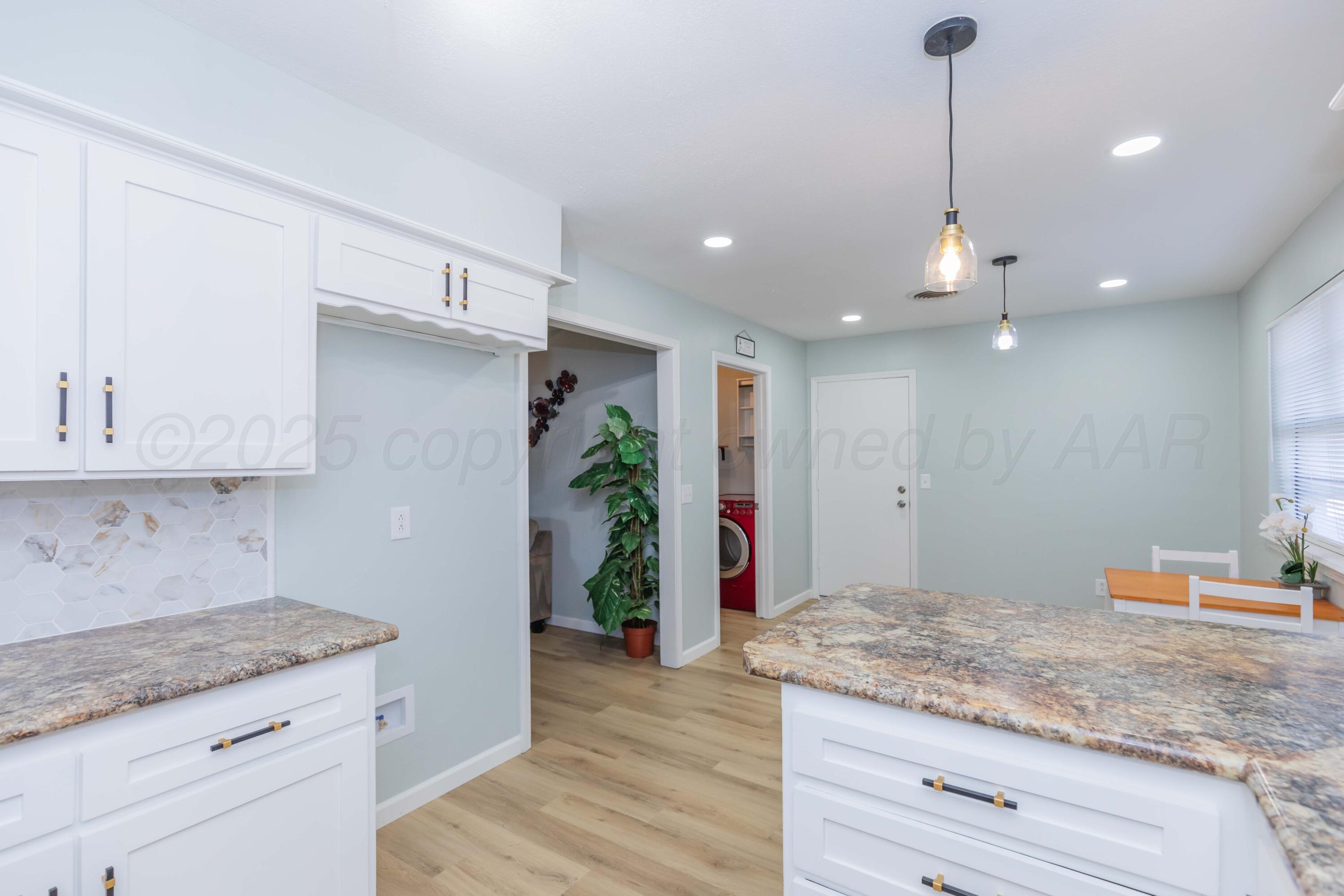 7912 Gerald Drive Amarillo, TX 79121 - Photo 15 of 45 a kitchen with granite countertop kitchen island sink stove and refrigerator