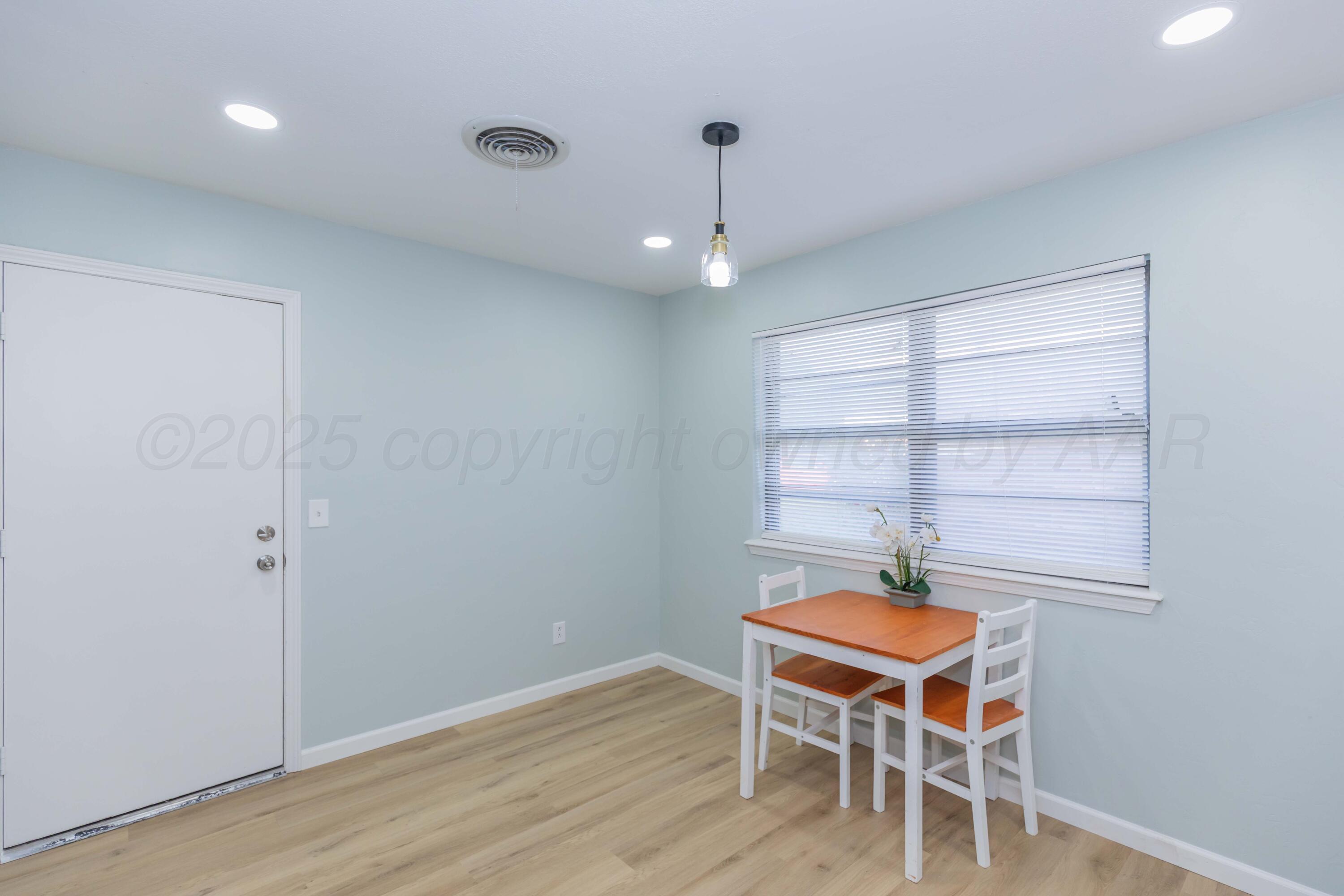 7912 Gerald Drive Amarillo, TX 79121 - Photo 17 of 45 a room with wooden floors and window