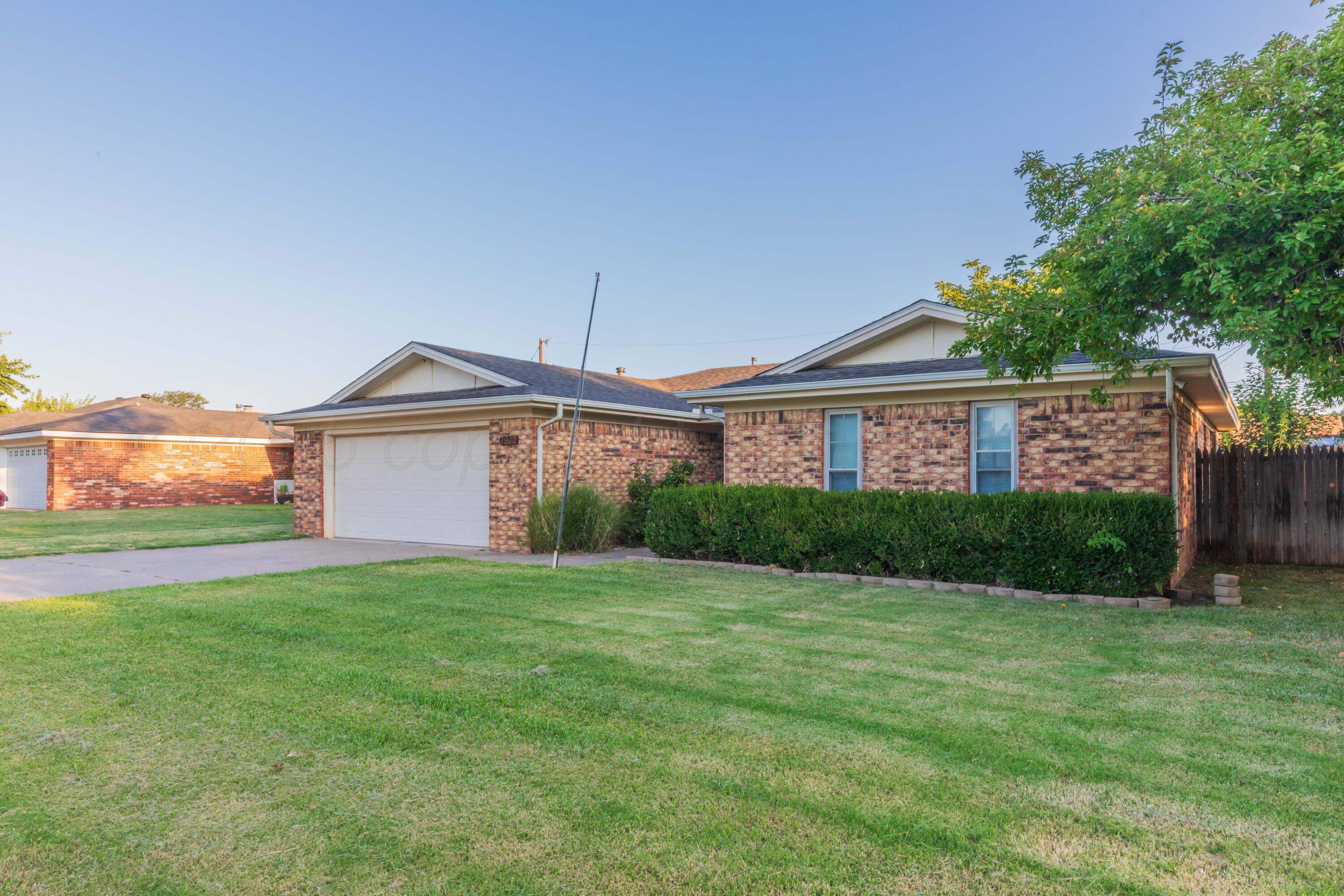 7912 Gerald Drive Amarillo, TX 79121 - Photo 2 of 45 a front view of a house with a yard and garage