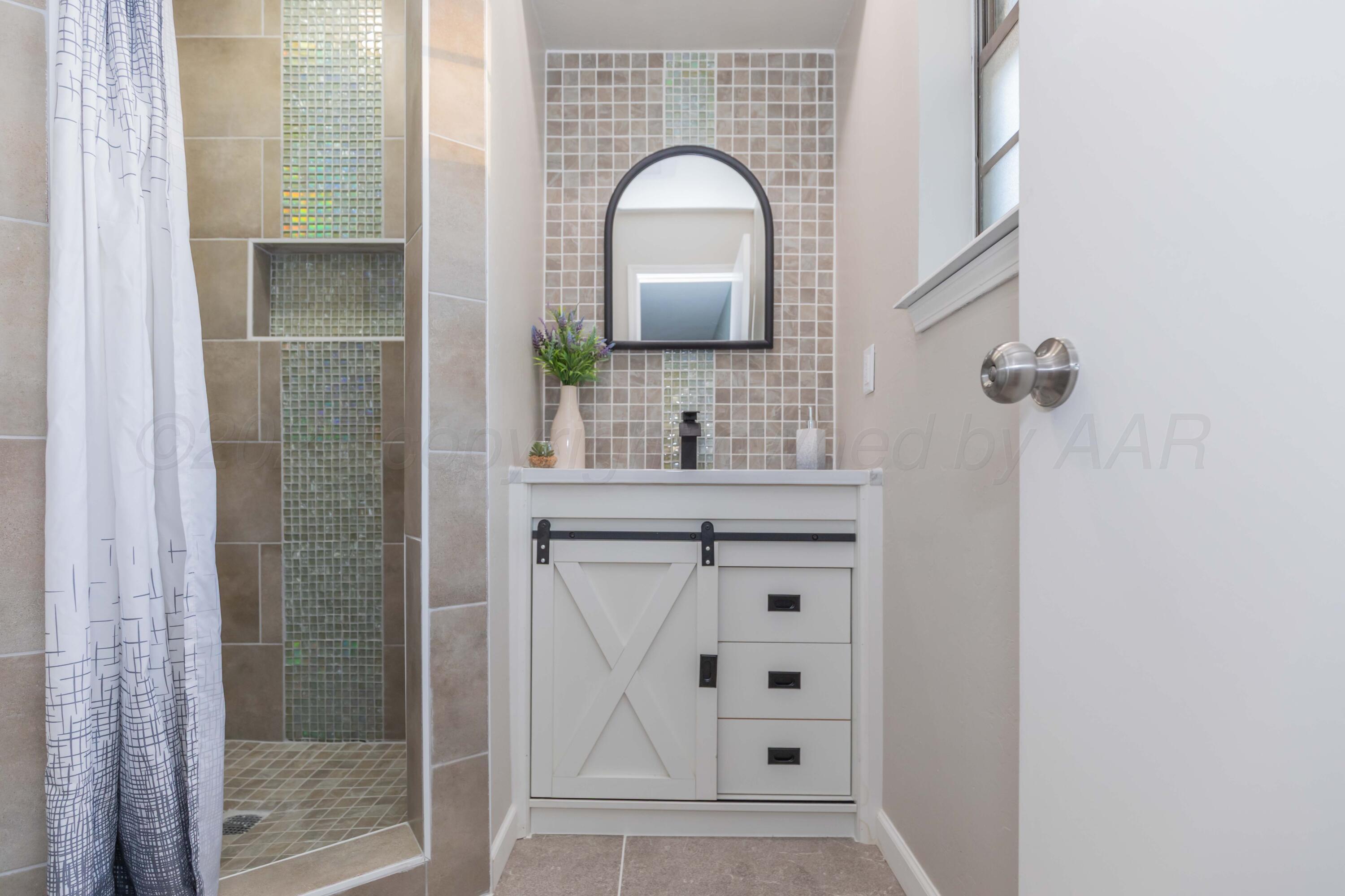 7912 Gerald Drive Amarillo, TX 79121 - Photo 25 of 45 a bathroom with a sink and a mirror