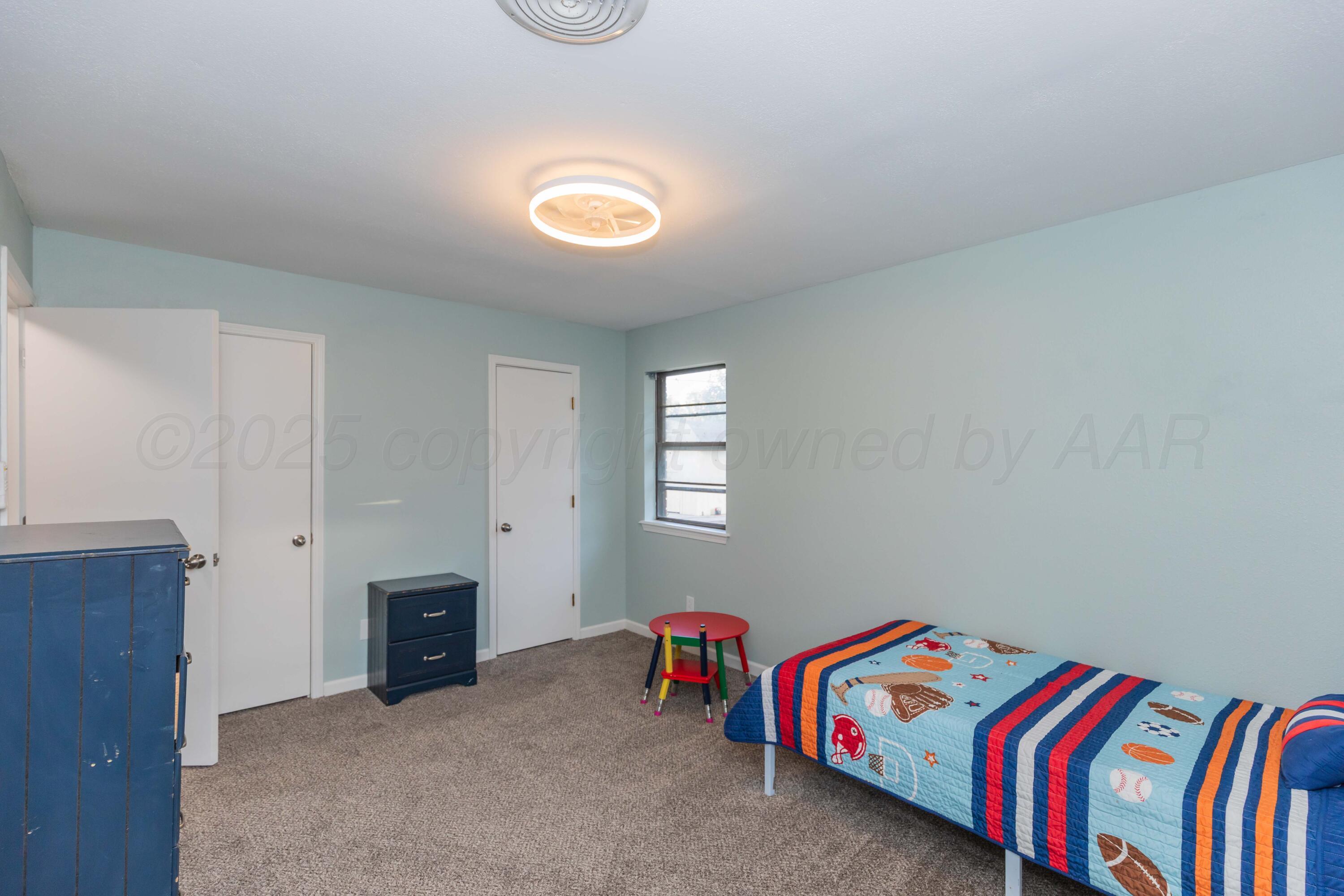 7912 Gerald Drive Amarillo, TX 79121 - Photo 28 of 45 a bedroom with a bed and a dresser in it