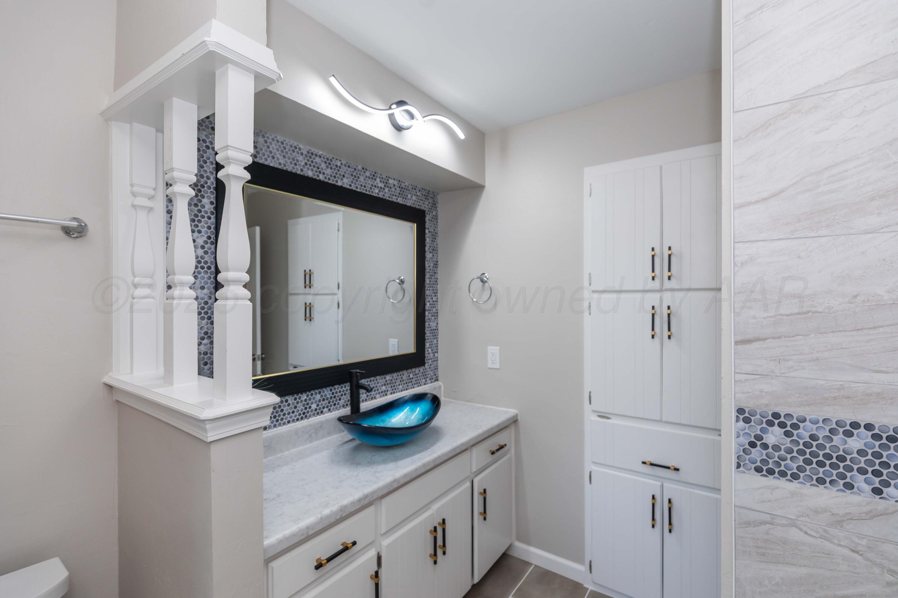 7912 Gerald Drive Amarillo, TX 79121 - Photo 29 of 45 a bathroom with a sink vanity and a mirror