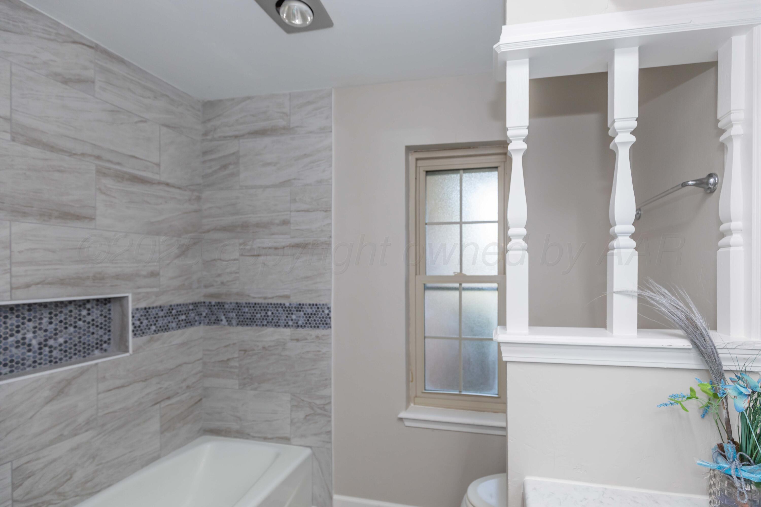 7912 Gerald Drive Amarillo, TX 79121 - Photo 30 of 45 a bath tub sitting next to a window