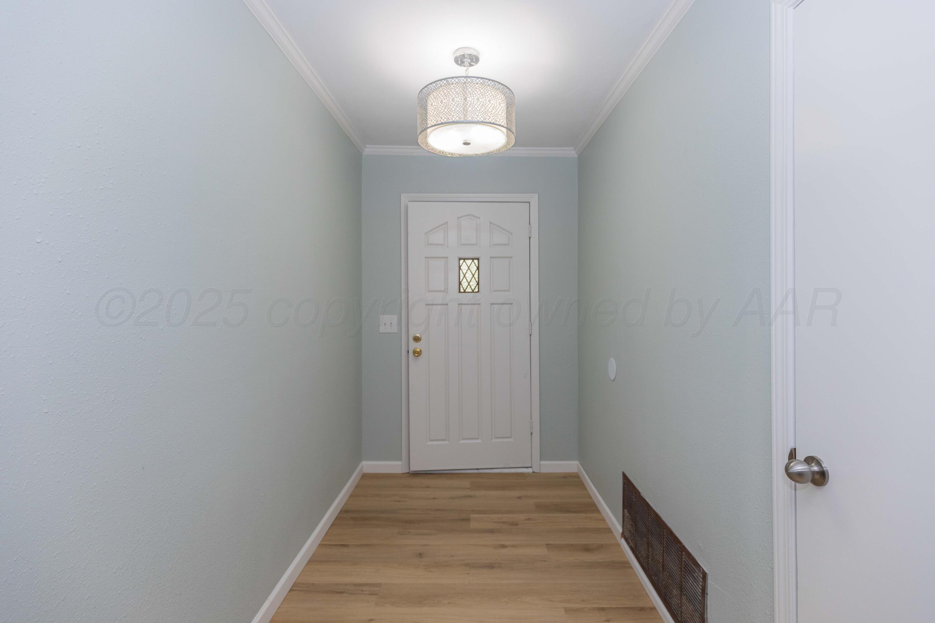 7912 Gerald Drive Amarillo, TX 79121 - Photo 4 of 45 a view of a hallway with wooden floor