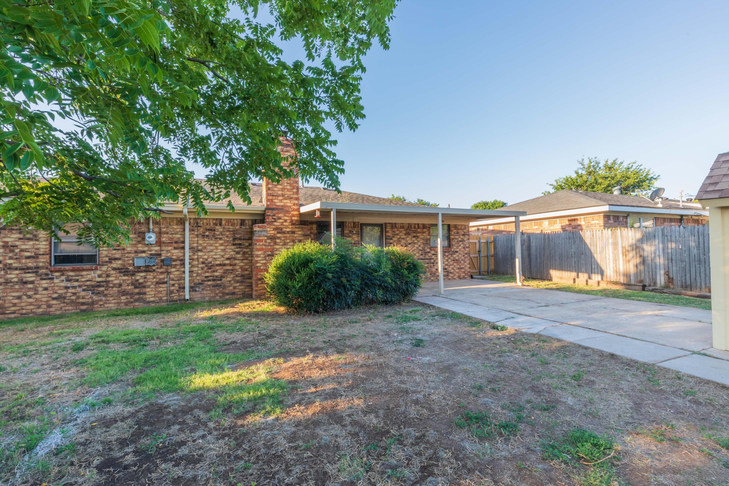 7912 Gerald Drive Amarillo, TX 79121 - Photo 41 of 45 a view of a backyard with a garden and tree