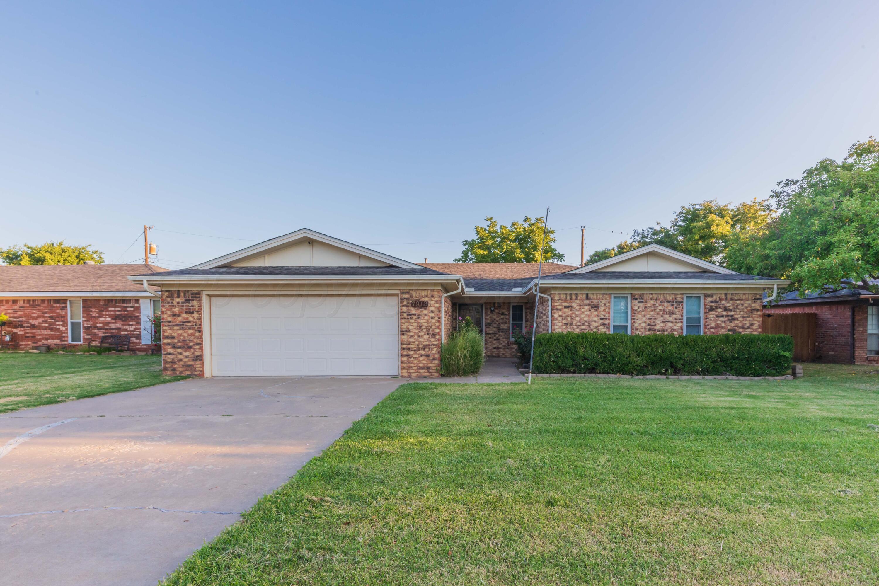 7912 Gerald Drive Amarillo, TX 79121 - Photo 45 of 45 a front view of a house with a yard and garage