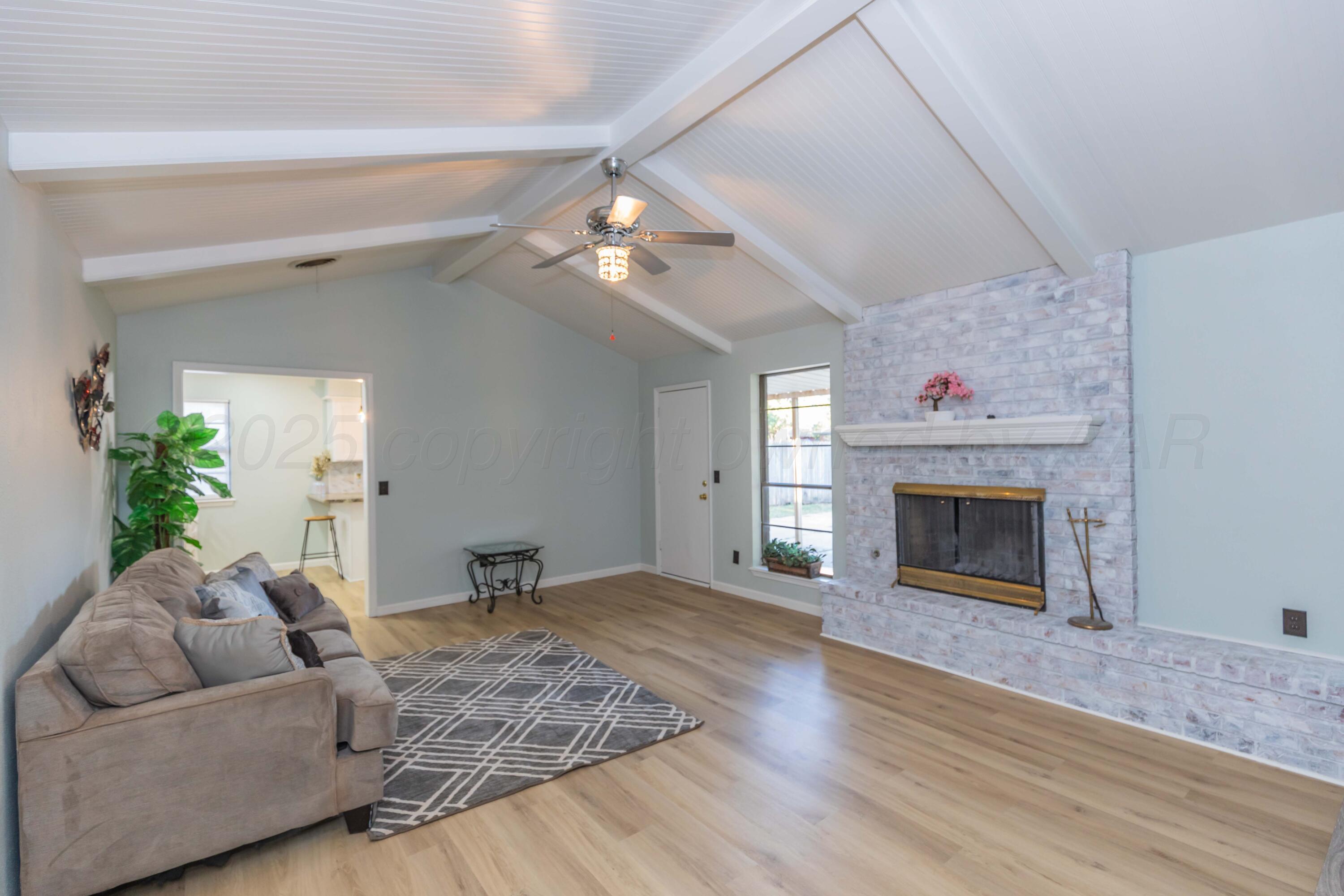 7912 Gerald Drive Amarillo, TX 79121 - Photo 5 of 45 a living room with furniture and a fireplace