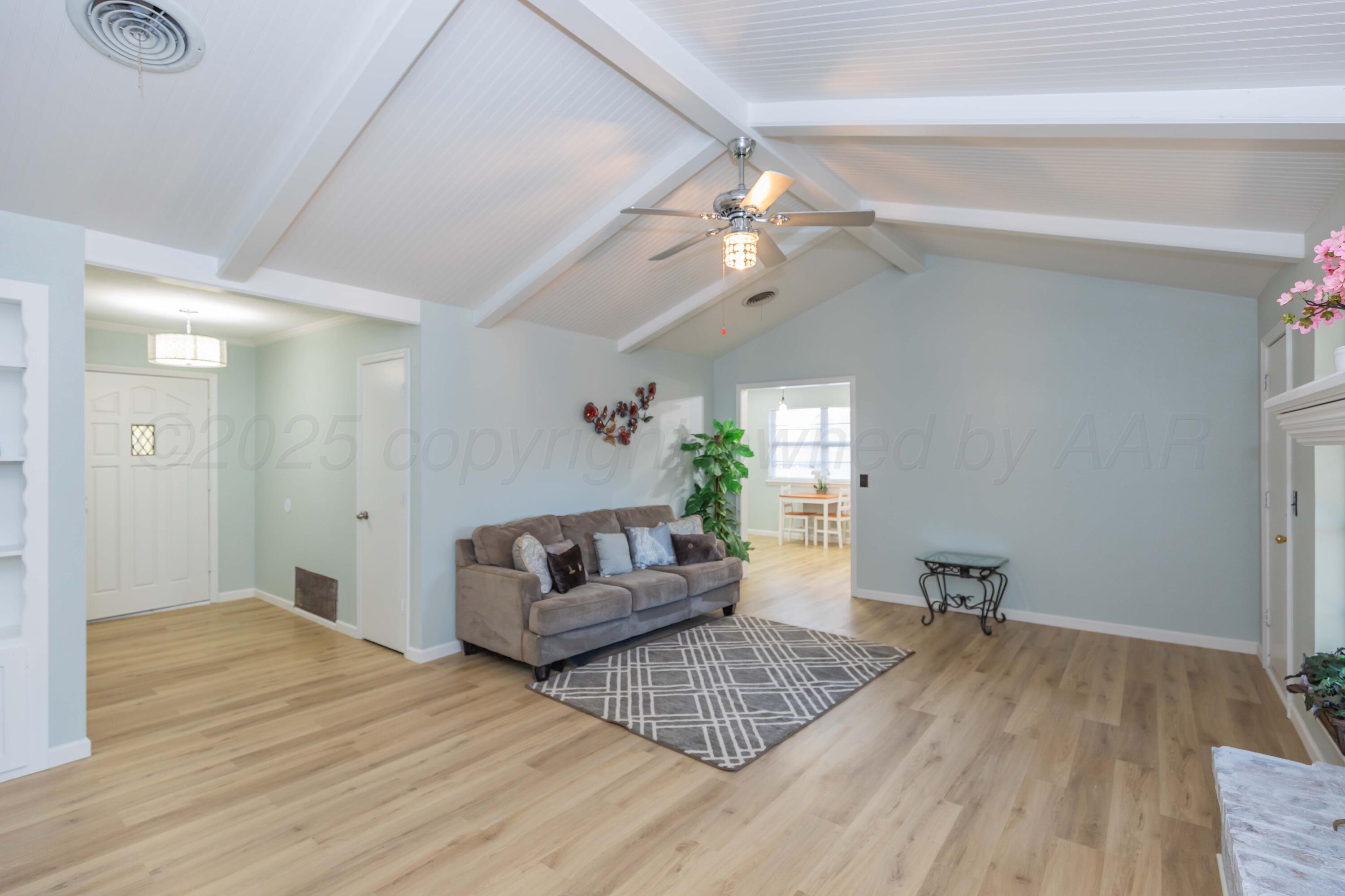 7912 Gerald Drive Amarillo, TX 79121 - Photo 7 of 45 a living room with furniture and a chandelier