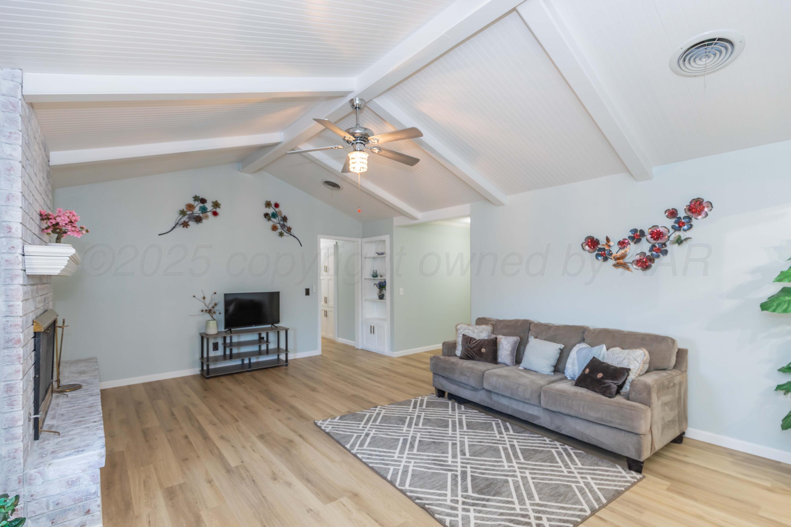 7912 Gerald Drive Amarillo, TX 79121 - Photo 8 of 45 a living room with furniture and a flat screen tv