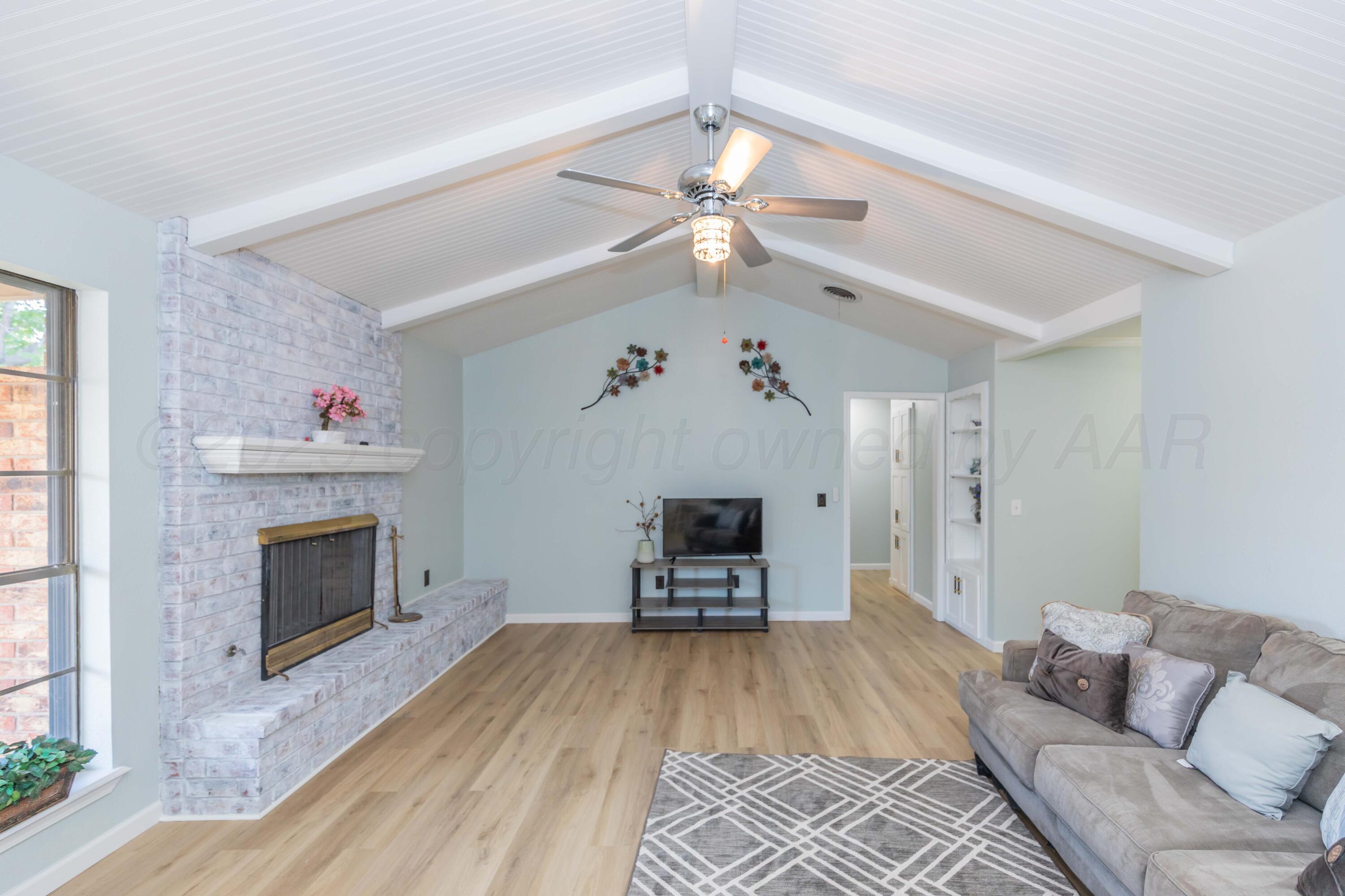 7912 Gerald Drive Amarillo, TX 79121 - Photo 9 of 45 a living room with furniture and a fireplace