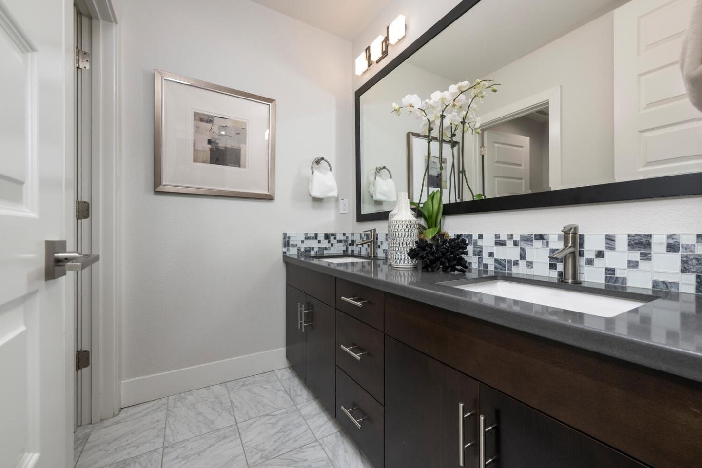 2903 Baze Road San Mateo, CA 94403 - Photo 23 of 31 a bathroom with a double vanity sink and a mirror