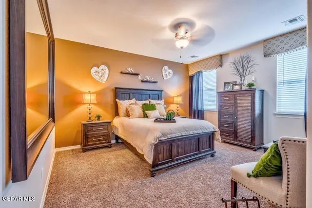 a spacious bedroom with a bed and a chandelier