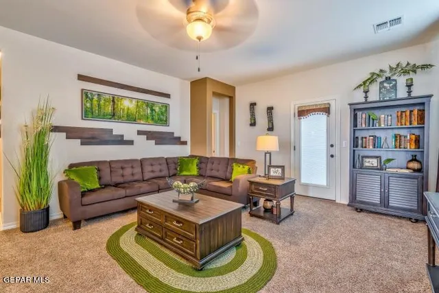 a living room with furniture and a piano