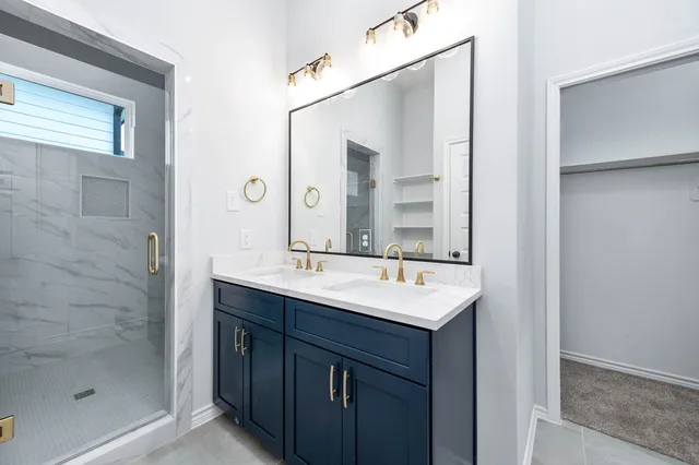 a bathroom with a sink a mirror and shower