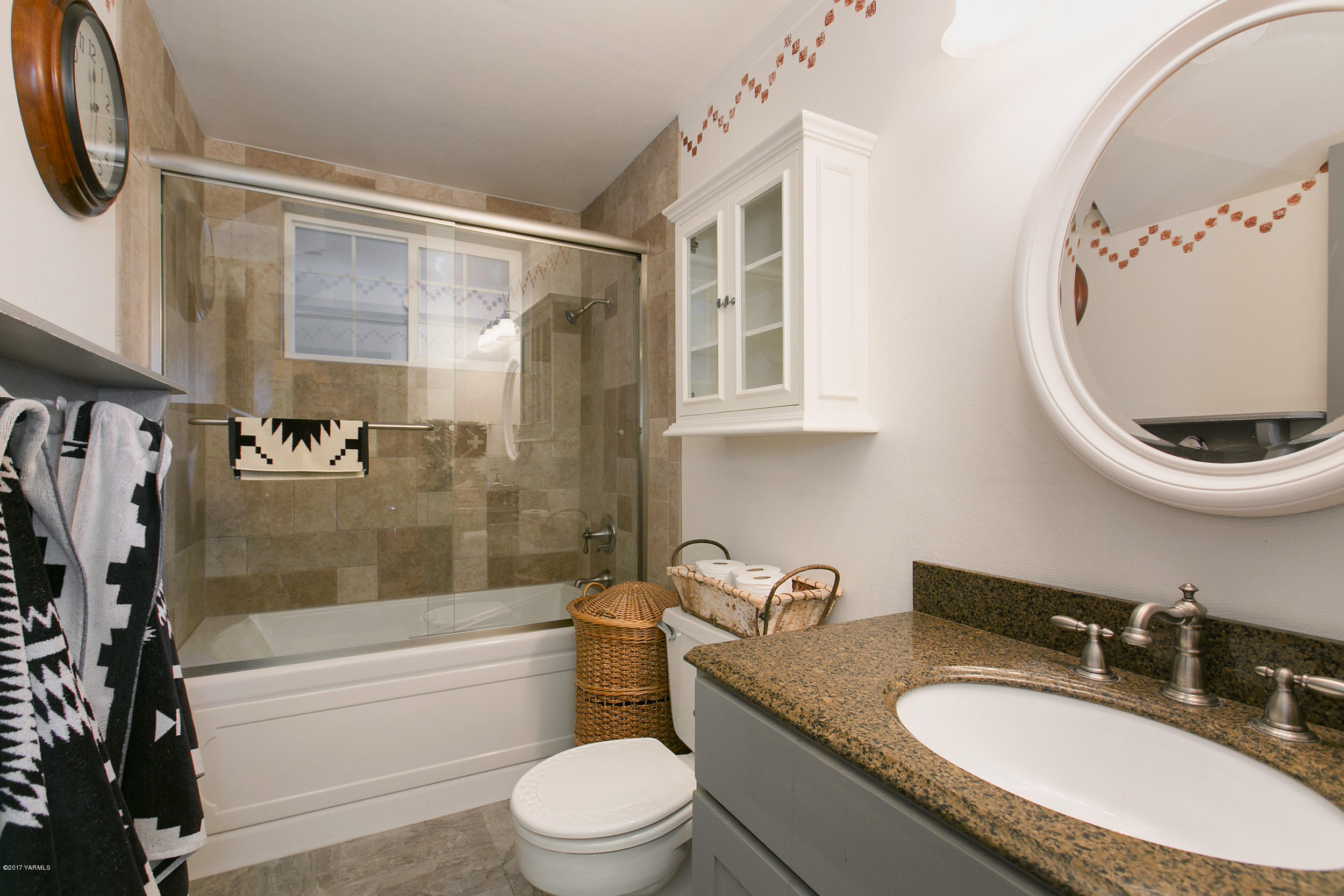 7503 Bittner Road Yakima, WA 98901 - Photo 17 of 31 a bathroom with a granite countertop sink mirror toilet and bathtub