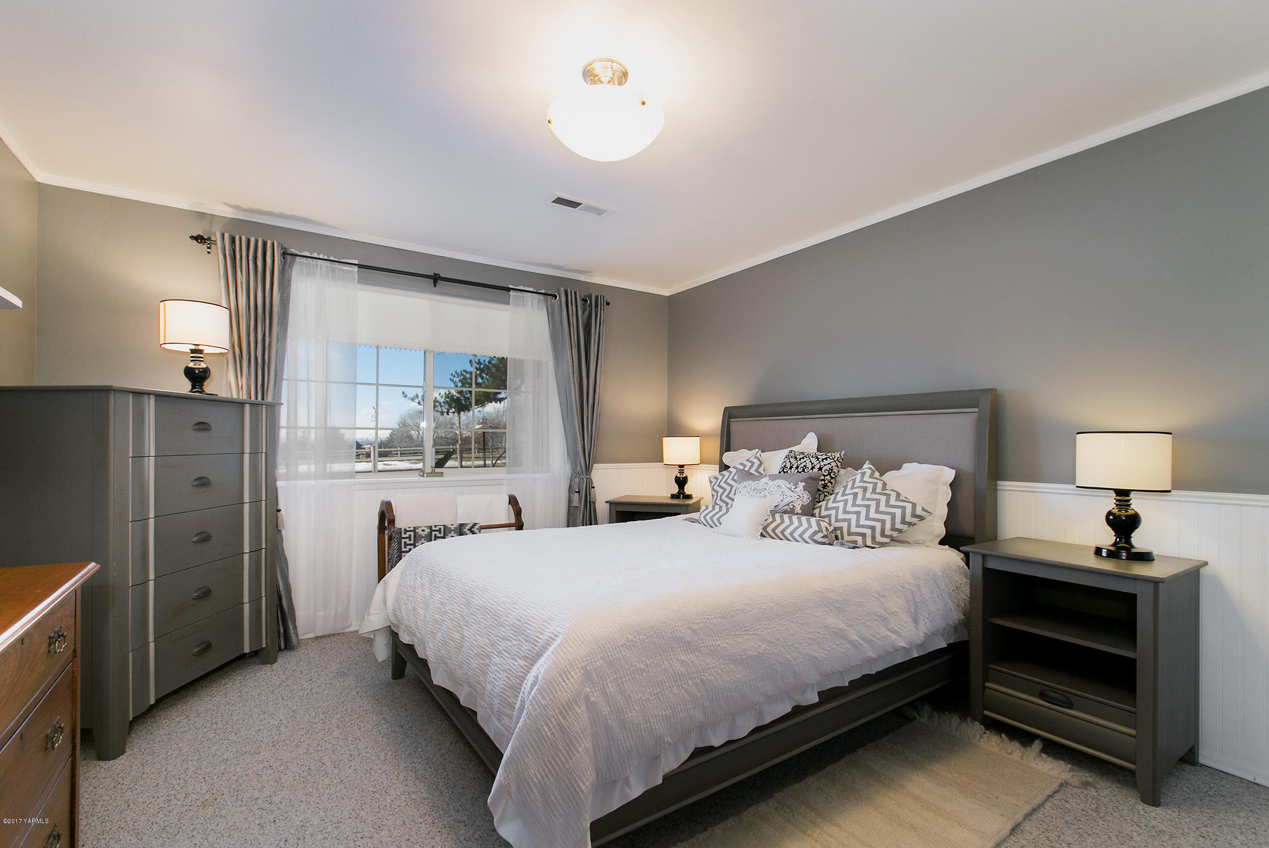 7503 Bittner Road Yakima, WA 98901 - Photo 18 of 31 a bedroom with a bed and a lamp