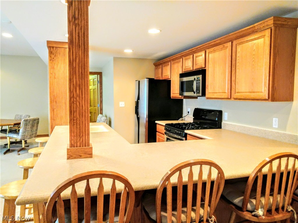 5136 Burnett Road Kent, OH 44240 - Photo 20 of 28 BELIEVE it or NOT...this is the lower level Kitchen! Stainless appliances are negotiable. Large eat on bar. Straight back is another huge pantry