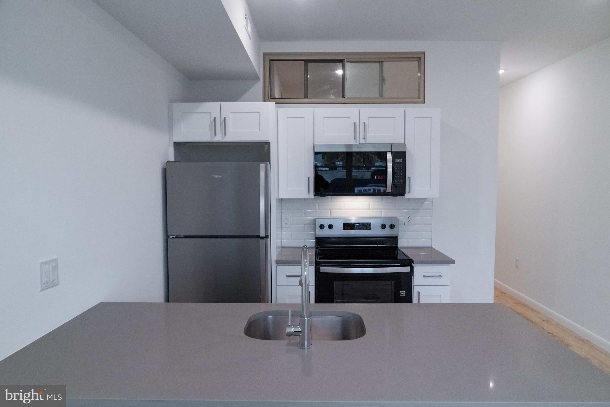 7248 Rising Sun Avenue Philadelphia, PA 19111 - Photo 6 of 36 a kitchen with stainless steel appliances a refrigerator and a stove top oven