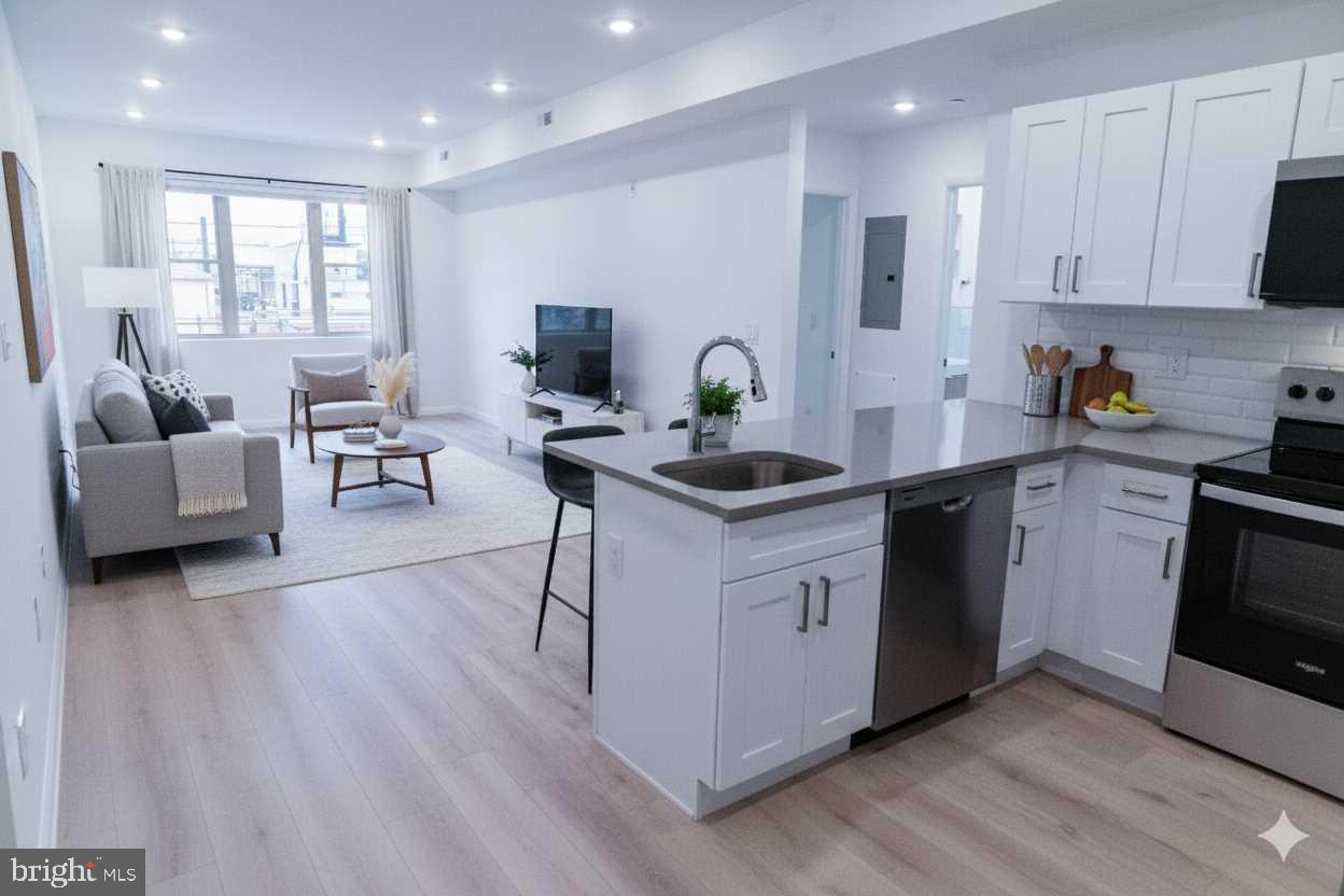 7248 Rising Sun Avenue Philadelphia, PA 19111 - Photo 10 of 36 a kitchen with stainless steel appliances granite countertop a stove a sink dishwasher a microwave oven and a dining table with wooden floor