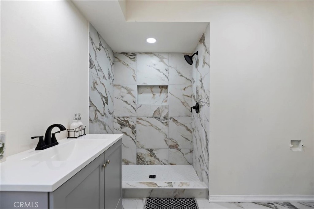 1748 Prince Albert Drive Riverside, CA 92507 - Photo 28 of 42 a bathroom with a sink and mirror with bathtub
