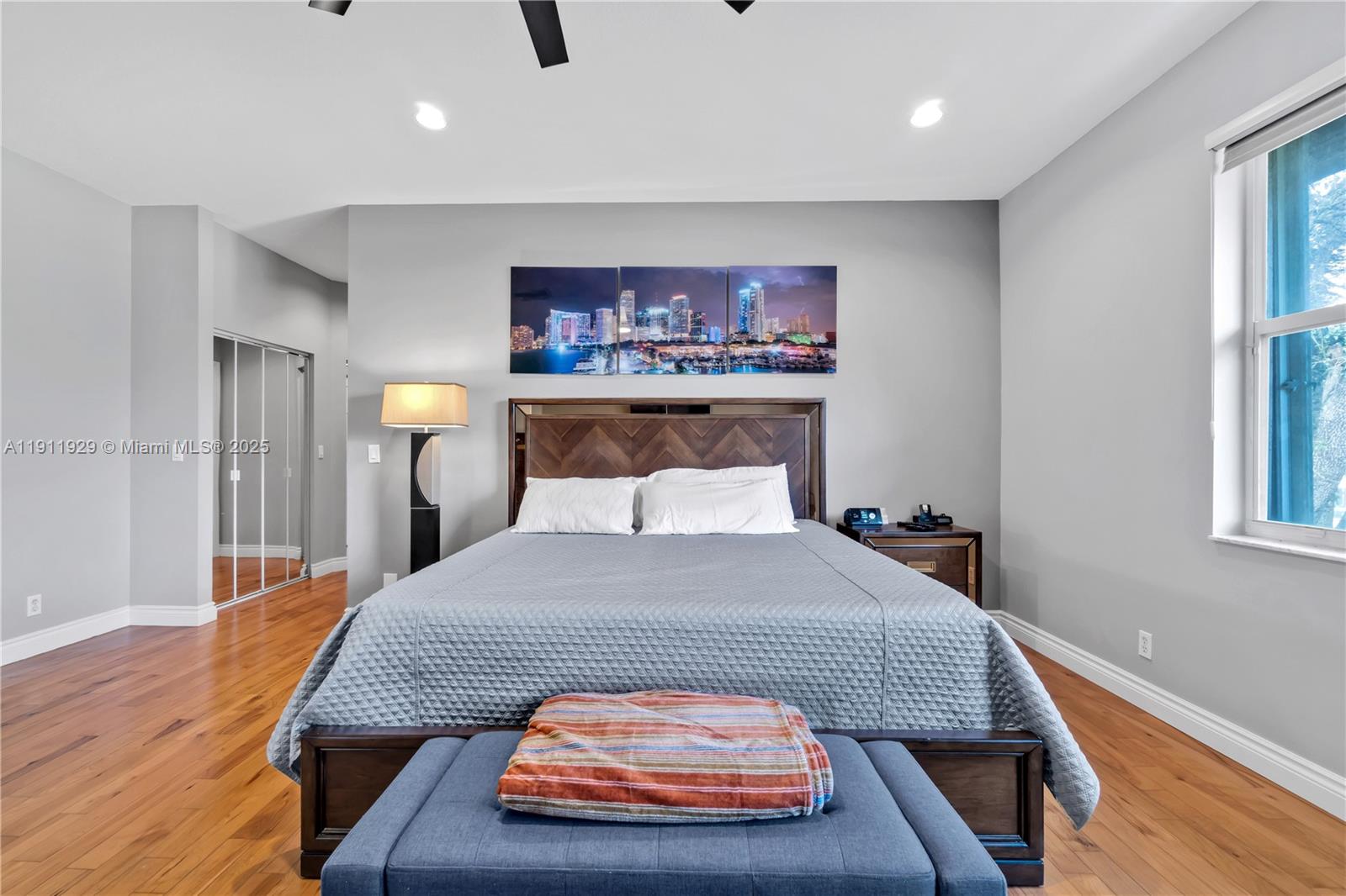 15841 Southwest 61st Street, Unit 15841 Davie, FL 33331 - Photo 23 of 49 a bedroom with a bed and wooden floor