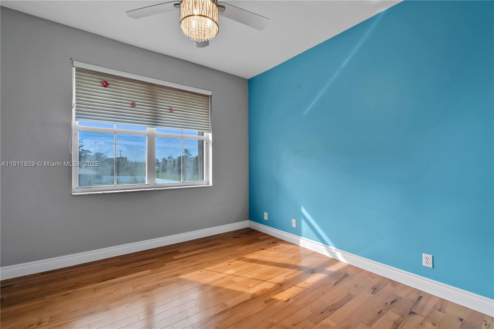15841 Southwest 61st Street, Unit 15841 Davie, FL 33331 - Photo 27 of 49 a view of an empty room with window and wooden floor
