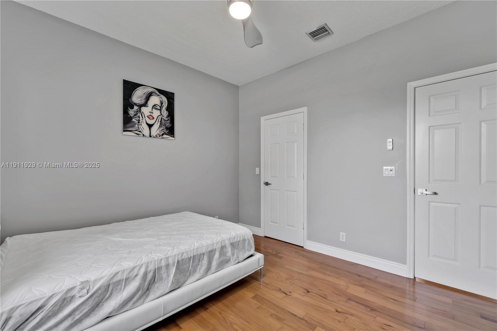 15841 Southwest 61st Street, Unit 15841 Davie, FL 33331 - Photo 30 of 49 a bedroom with a bed and a chandelier