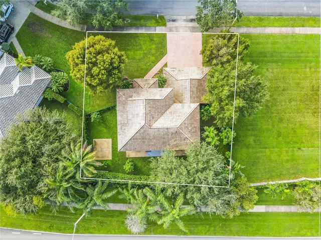 an aerial view of a house with a yard